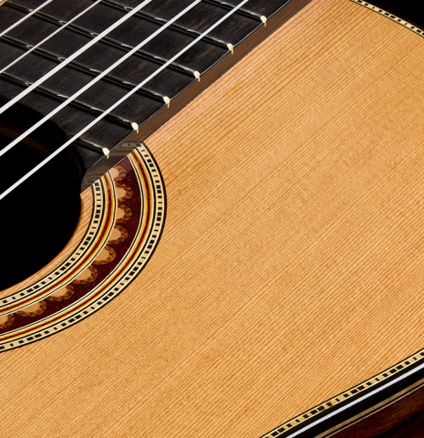 The soundboard, rosette and fingerboard of a 2025 Henrik Ballowitz classical guitar made of cedar and African Blackwood