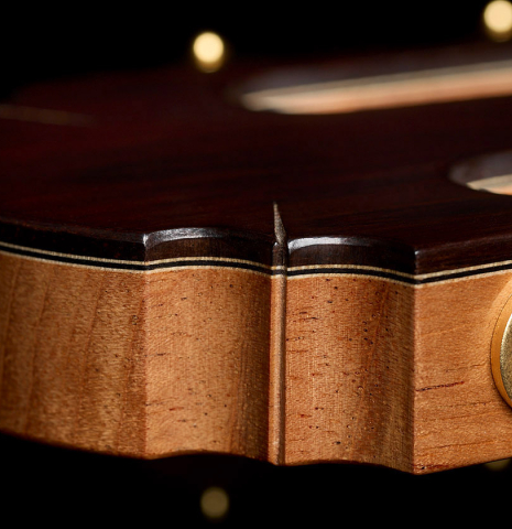 The carved headstock shape of a 2026 Henrik Ballowitz classical guitar made of spruce and Indian rosewood