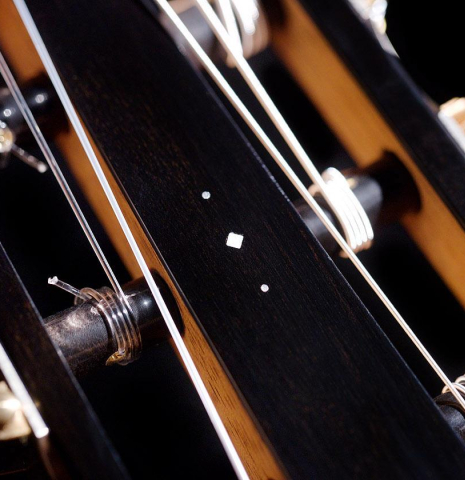 The headstock and tuners of a 2020 Kris Barnett classical guitar made with cedar and African rosewood