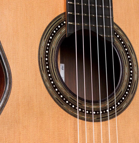 The soundboard and rosette of a 2020 Kris Barnett classical guitar made with cedar and African rosewood