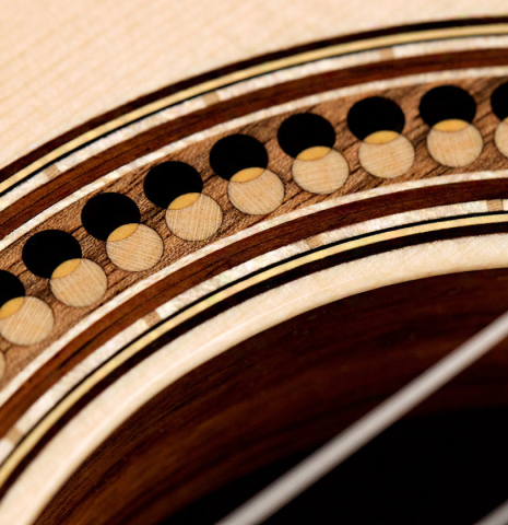 The rosette of a 2022 Marco Bortolozzo classical guitar made with spruce and exotic ebony