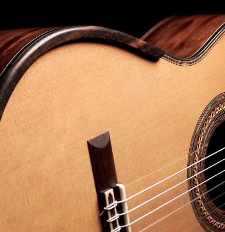 The soundboard and armrest of a 2023 Kris Barnett classical guitar made with cedar and exotic ebony