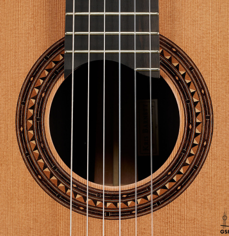 The rosette of a 2025 Kris Barnett classical guitar made of cedar and exotic ebony
