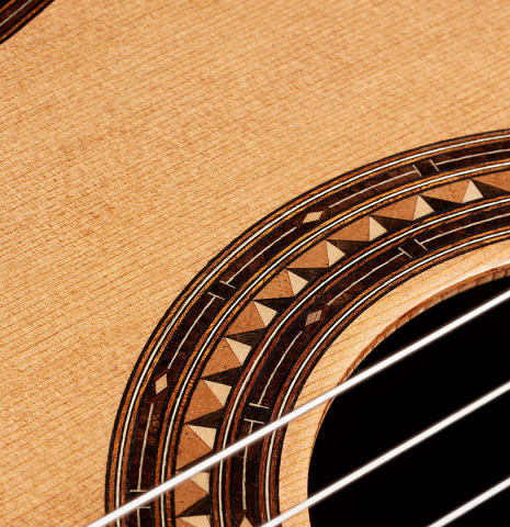 Closeup of the rosette of a 2025 Kris Barnett classical guitar made of cedar and exotic ebony