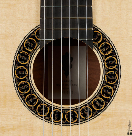 The rosette of a 2025 Marco Bortolozzo classical guitar made of spruce and pomellè mahogany