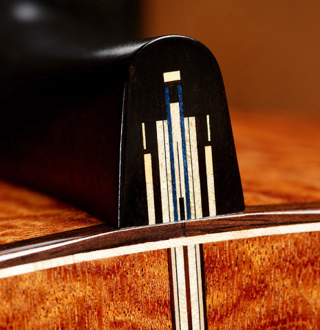 The heal cap of a 2025 Marco Bortolozzo classical guitar made of spruce and pomellè mahogany