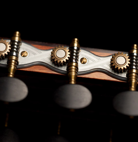 The machine heads of a 2016 Michel Belair classical guitar made of cedar and Indian rosewood