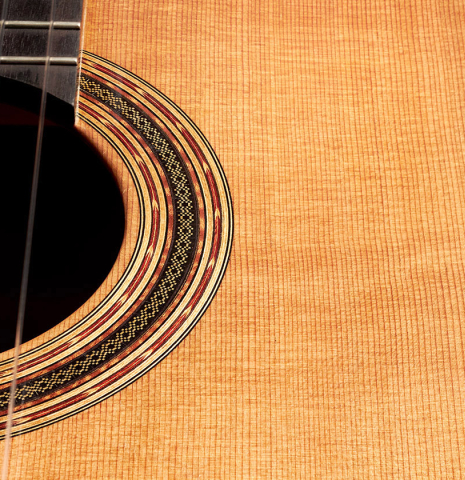 Closeup of the rosette of a 2016 Michel Belair classical guitar made of cedar and Indian rosewood