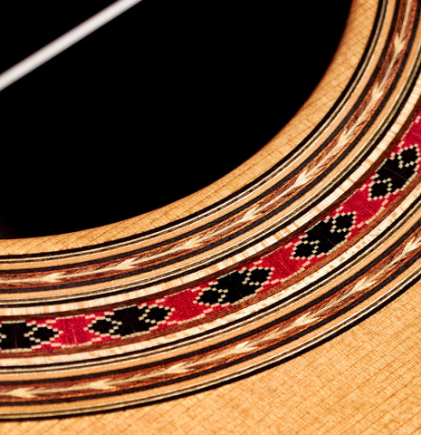 The rosette of a 2022 Michel Belair "Hommage a Daniel Friederich" classical guitar made of cedar and Indian rosewood