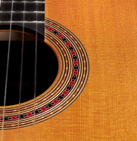 The top and rosette of a 2024 Michel Belair "Hommage a Daniel Friederich" classical guitar made of cedar and Indian rosewood