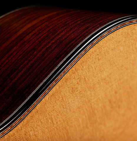 The top binding and purfling of a 2025 Michel Belair "Double Top" classical guitar made of cedar and Indian rosewood