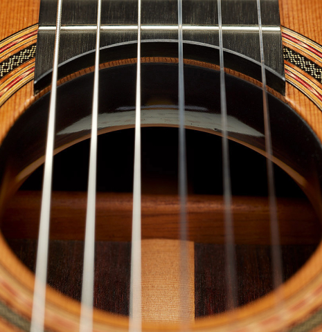 The soundhole and tornavoz of a 2025 Michel Belair "Double Top" classical guitar made of cedar and Indian rosewood