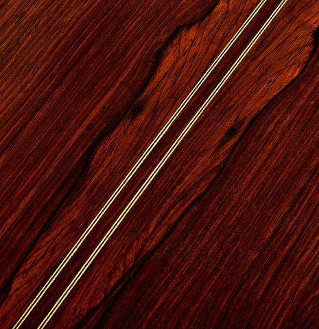 The back center seam of a 1999 Jose Lopez Bellido classical guitar made of spruce and CSA rosewood