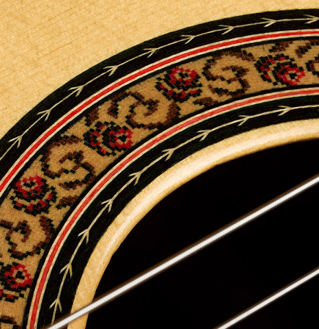 Closeup detail of the rosette of a 1999 Jose Lopez Bellido classical guitar made of spruce and CSA rosewood