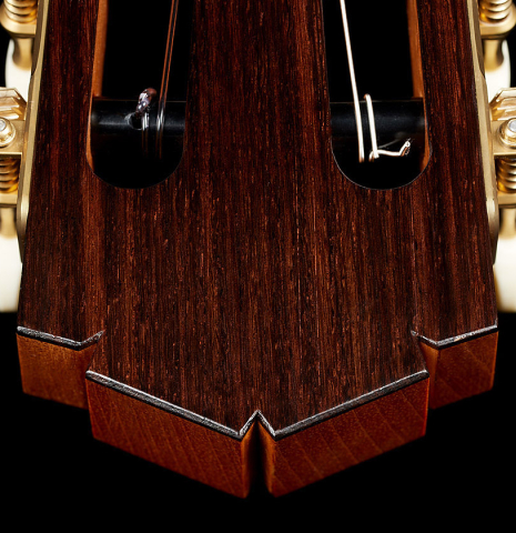 The headstock veneer of a 2025 Tobias Berg classical guitar made of cedar and Indian rosewood