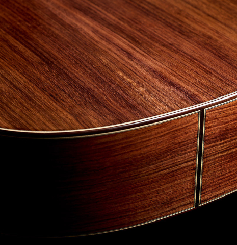 The back and sides at the foot of a 2025 Tobias Berg classical guitar made of cedar and Indian rosewood