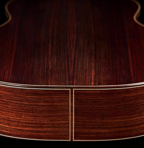 The back and sides at the foot of a 2024 Tobias Berg classical guitar made of spruce and Indian rosewood