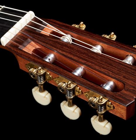 The headstock and tuning machines of a 2024 Tobias Berg classical guitar made of spruce and Indian rosewood