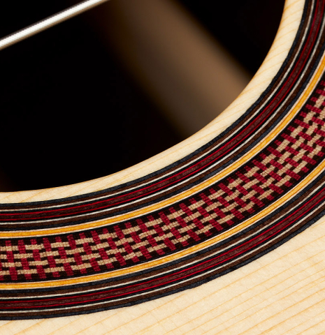 Closeup detail of the rosette of a 2024 Tobias Berg classical guitar made of spruce and Indian rosewood