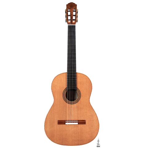 The front of a 2022 Tobias Berg classical guitar made of cedar and European walnut on a white background.