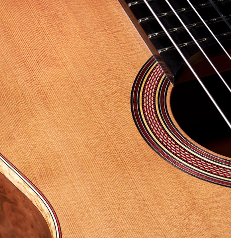 The soundboard of a 2022 Tobias Berg classical guitar made of cedar and European walnut.