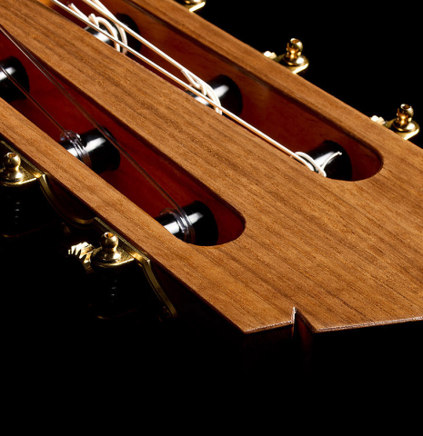 The headstock and tuning machines of a 2025 Tobias Berg classical guitar made of cedar and walnut