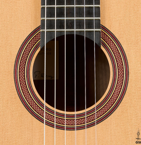 The rosette of a 2025 Tobias Berg classical guitar made of cedar and walnut