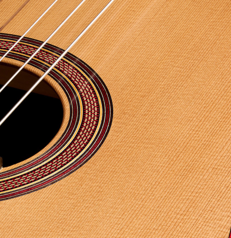 The soundboard and rosette of a 2025 Tobias Berg classical guitar made of cedar and walnut