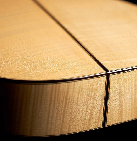 Back and sides at the foot of a 2023 Tobias Berg classical guitar made of spruce and flamed maple.