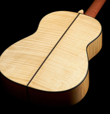 The back and sides of a 2023 Tobias Berg classical guitar made of spruce and flamed maple.