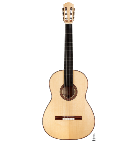 The front of a 2023 Tobias Berg classical guitar made of spruce and flamed maple on a white background.