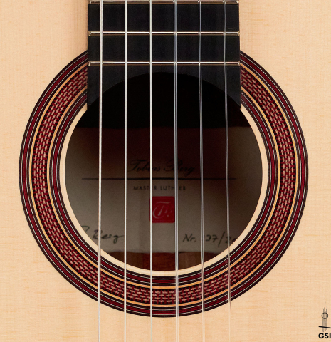 The rosette of a 2022 Tobias Berg guitar made with spruce and walnut wood.