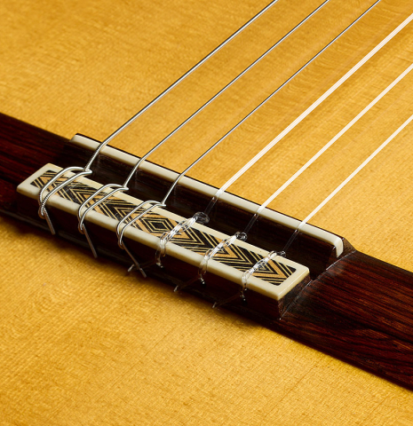 The bridge, tie-block and saddle of a 2001 Paulino Bernabe "Imperial" classical guitar made of spruce and CSA rosewood