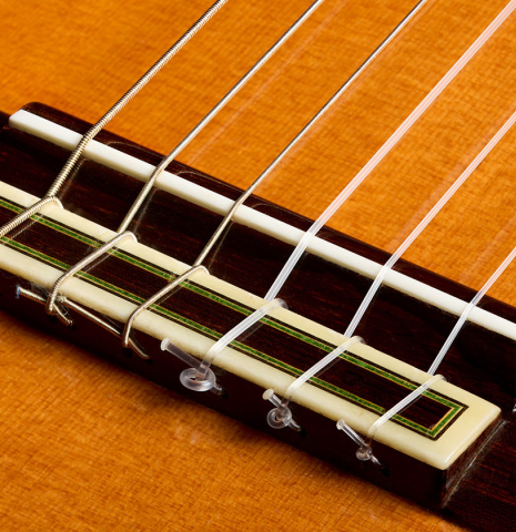 The bridge, tie-block and saddle of a 1972 Paulino Bernabe classical guitar made of cedar and Indian rosewood
