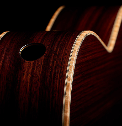 The back, sides, sound-port and maple binding of a 2026 Martin Blackwell "640" double-top classical guitar made of spruce and Indian rosewood
