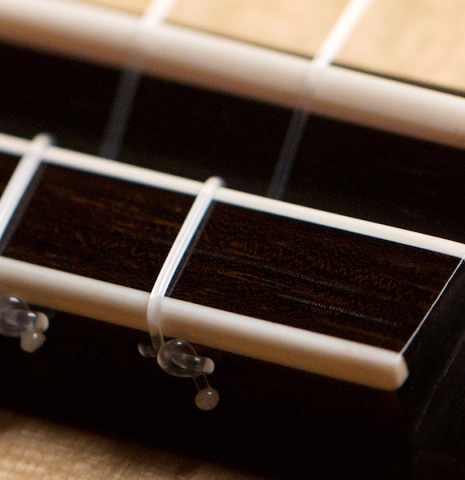This is a close-up of the bridge, saddle and tie-block of a 2021 Edmund Blöchinger SP/CSAR classical guitar