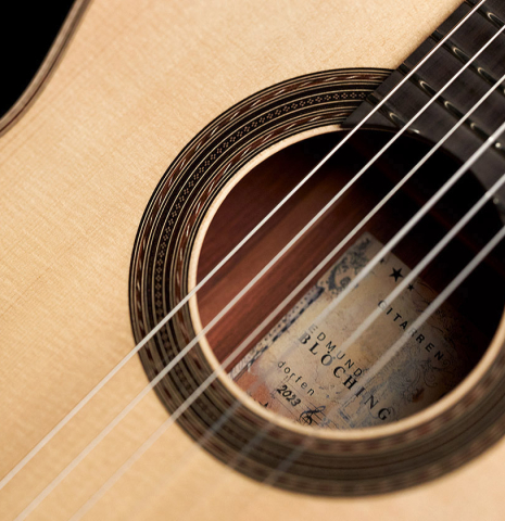 The soundboard and rosette of a 2023 Edmund Blöchinger "Llobet" classical guitar made with spruce top and CSA rosewood back and sides.