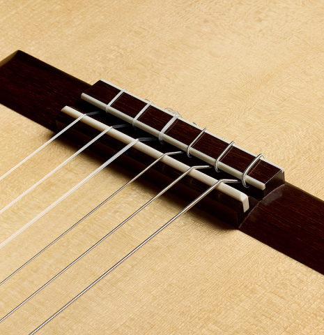 The bridge, tie-block and saddle of a 2025 Edmund Blöchinger "Llobet" classical guitar made of spruce and CSA rosewood