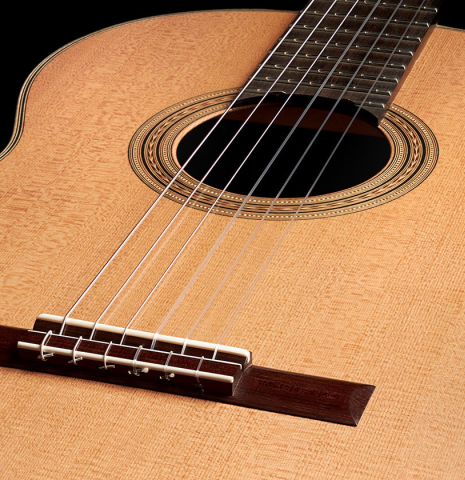 The bridge of a 2023 Edmund Blöchinger "Llobet" classical guitar made with cedar top and CSA rosewood back and sides.