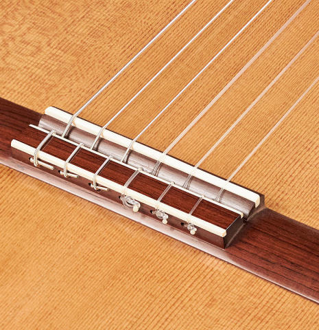 The bridge, saddle and tie-block of a 2023 Edmund Blöchinger "Llobet" classical guitar made with cedar top and CSA rosewood back and sides.
