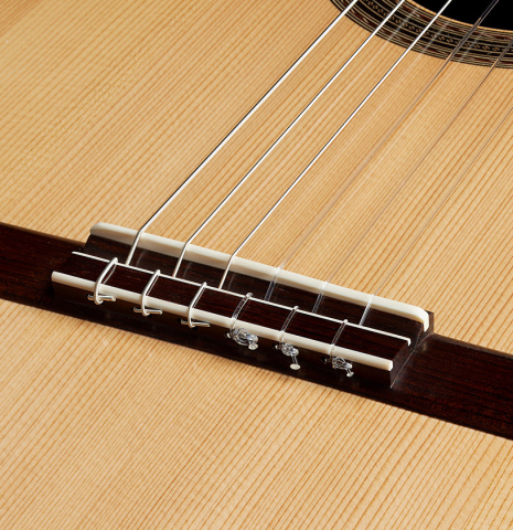 The bridge, tie-block and saddle of a 2024 Edmund Blöchinger "Dome" classical guitar made of spruce and CSA rosewood