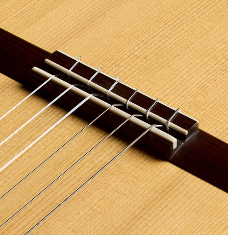The bridge, tie-block and saddle of a 2026 Edmund Blöchinger "Dome" classical guitar made of spruce and CSA rosewood