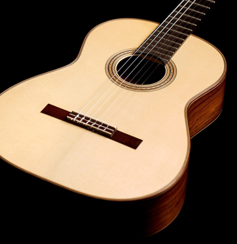 This is a 2000 Edmund Blochinger classical guitar made with spruce and csa rosewood on a black background