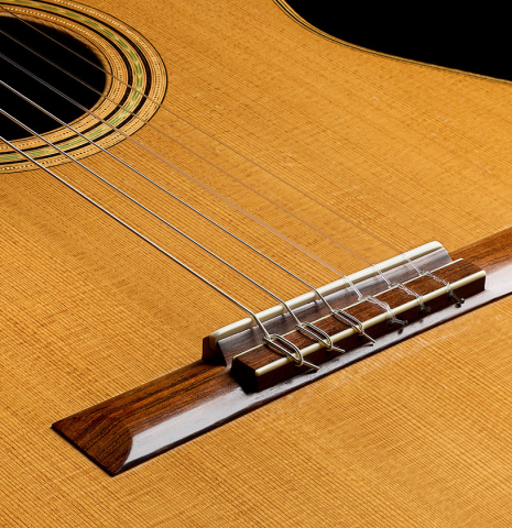 The bridge, tie-block and saddle of a 2003 Edmund Blöchinger classical guitar made of cedar and CSA rosewood