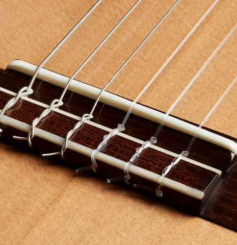The bridge, tie-block and saddle of a 2025 Elias Bonet classical guitar made of cedar and green ebony