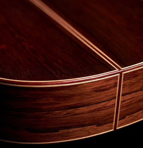 The back and sides at the foot of a 2023 Elias Bonet classical guitar made with spruce top and African rosewood back and sides