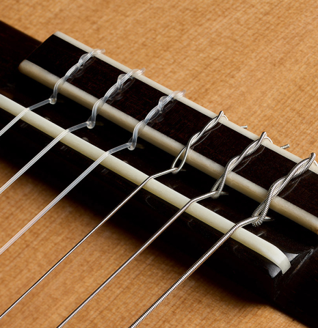 The bridge, tie-block and saddle of a 2026 Elias Bonet classical guitar made of cedar and African rosewood