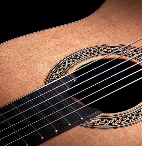 The soundboard of a 2023 Elias Bonet "Aire" classical guitar made of cedar and Green ebony.
