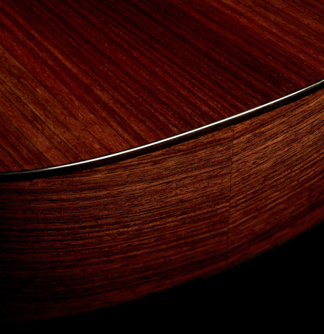 The back and side binding atthe foot of a 2026 Marco Bortolozzo "Furore" classical guitar made of cedar and Indian rosewood