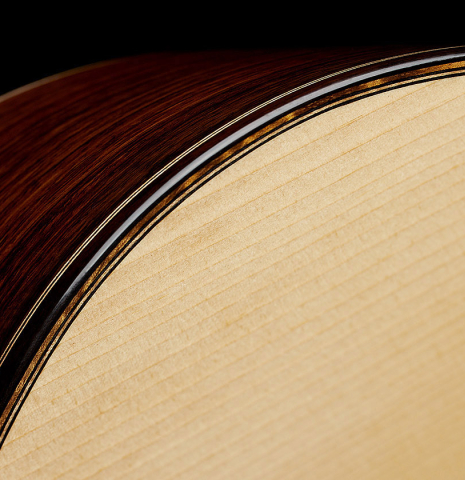 The top binding and purfling of a 2024 Eduardo Bossa classical guitar made of spruce and Indian rosewood